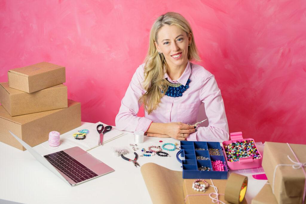 Freelancer working from home. Woman making jewellery and selling merchandise online.